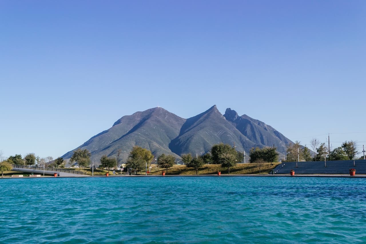 Paisaje montañoso con un lago, representando el compromiso de MMTubería con proyectos en entornos naturales.